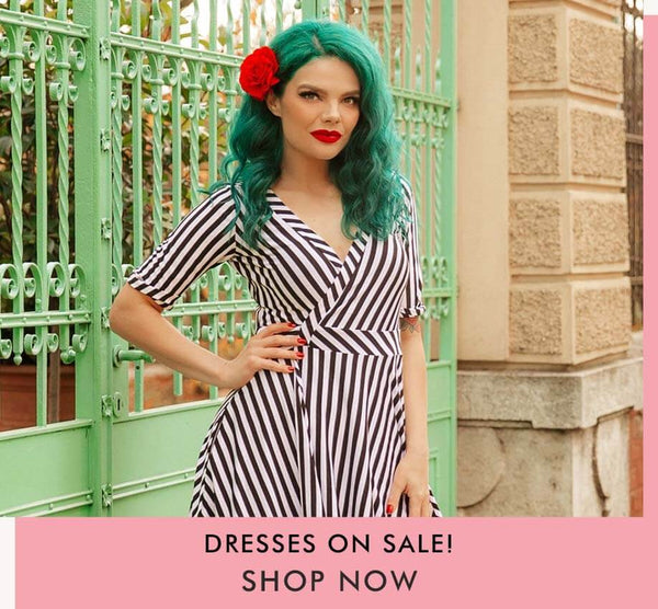 dresses on sale - model with striped retro wrap dress and hand on hip