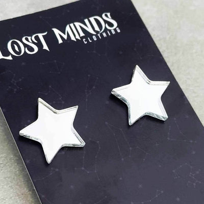 Alternative retro stud earrings. The earrings are star shapped in silver mirror acrylic and a on a "Lost Minds" branded cardbord display