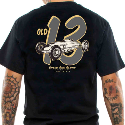 Back view of a tattoed man wearing a black t-shirt with a old 1950s style racing car print