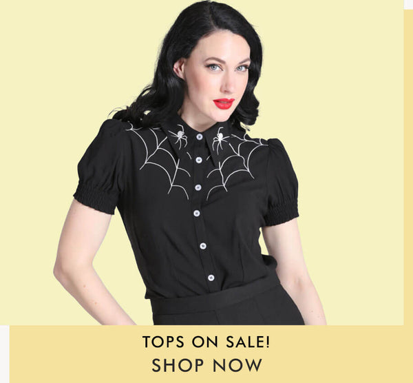 tops on sale - dark haired model in black blouse with spiderweb detailing