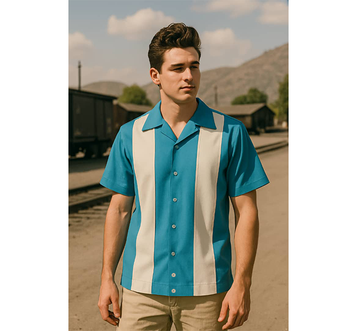 Man wearing Aqua and cream striped shirt standing in a desert-like setting with mountains in the background.