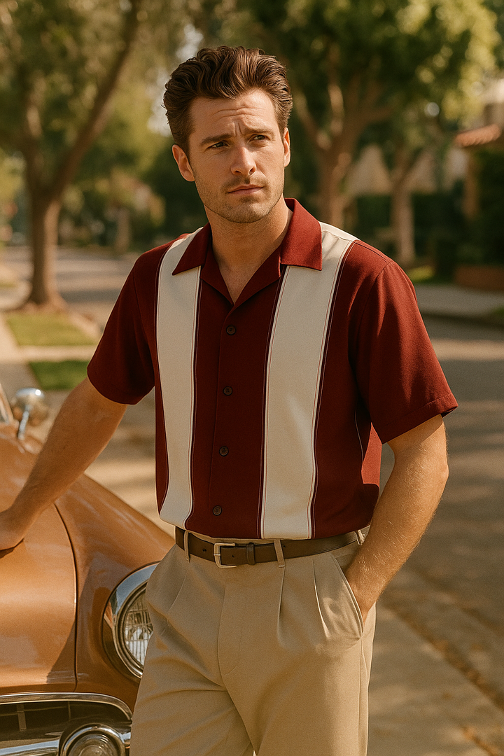 Man in a vintage outfit standing next to a classic car with trees in the background