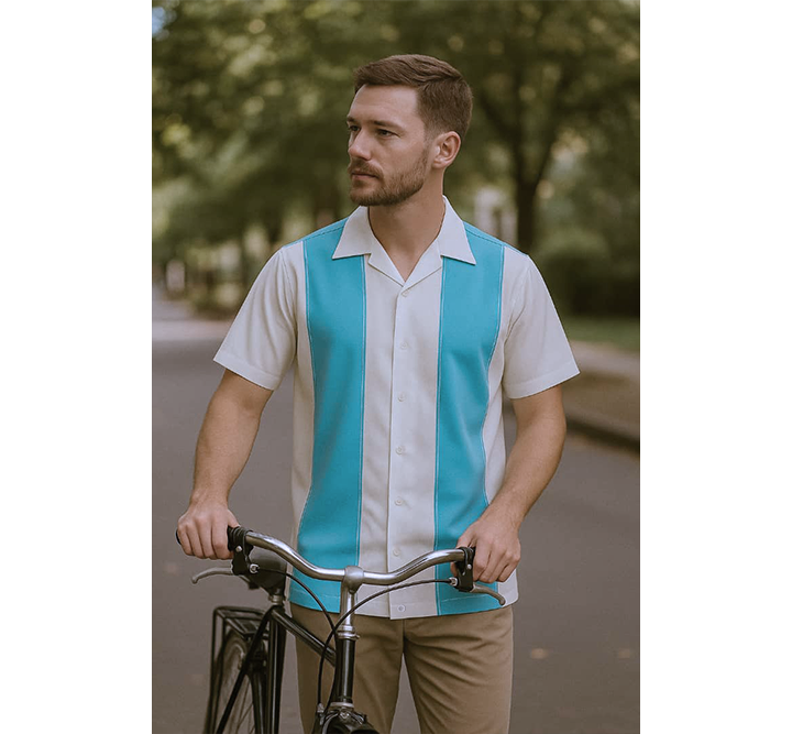 Man wearing a aqua and white striped shirt holding a bicycle outdoors.
