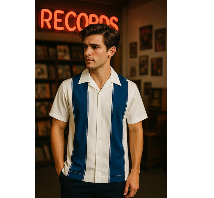 Man wearing a white and Navy striped shirt in a record store with a neon 'Records' sign.