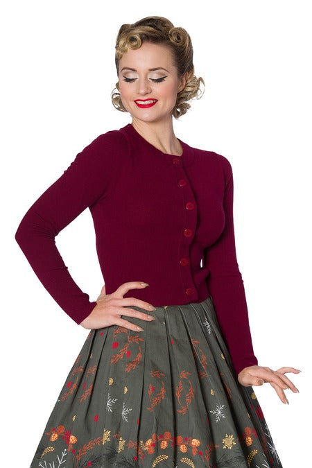 Burgundy cropped cardigan on lady with skirt with white background