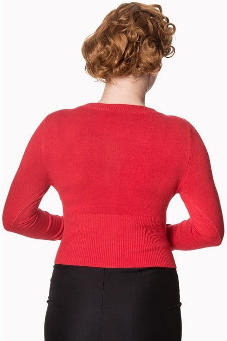 back Image of lady wearing a red cardigan with black skirt
