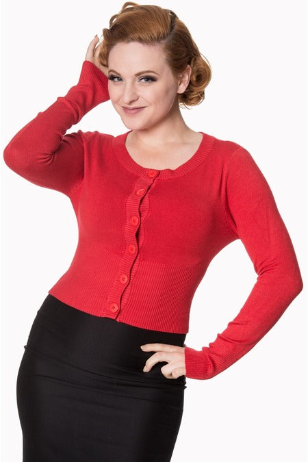 Image of lady wearing a red cardigan with black skirt