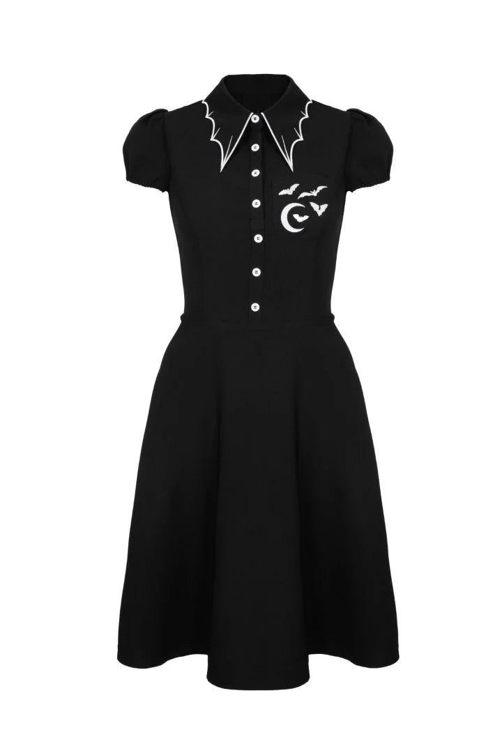 Black dress with white buttons and designs on a white background