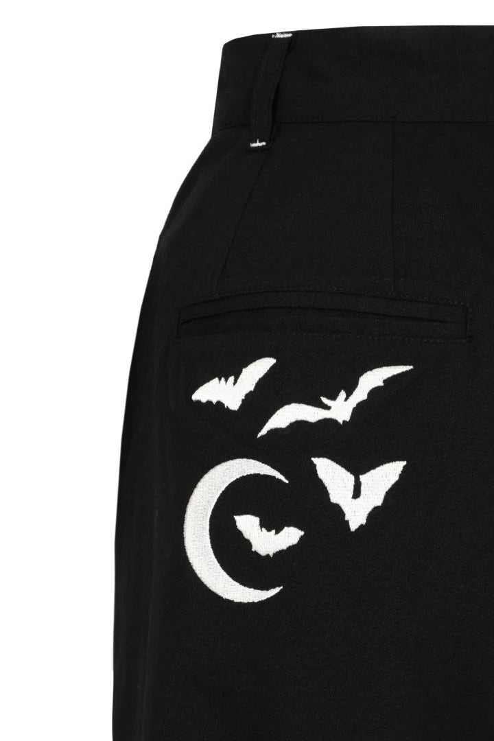 Black pants with white bat and moon design on a white background