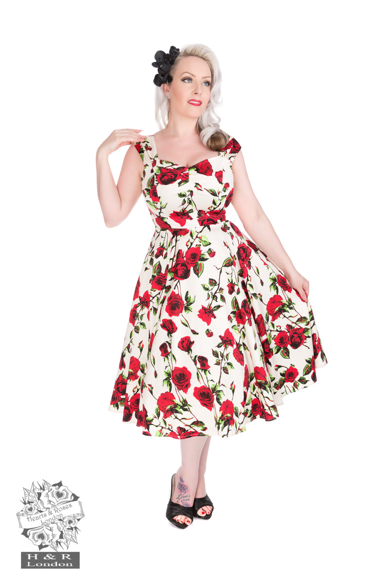 Woman wearing a floral dress with red flowers on a white background