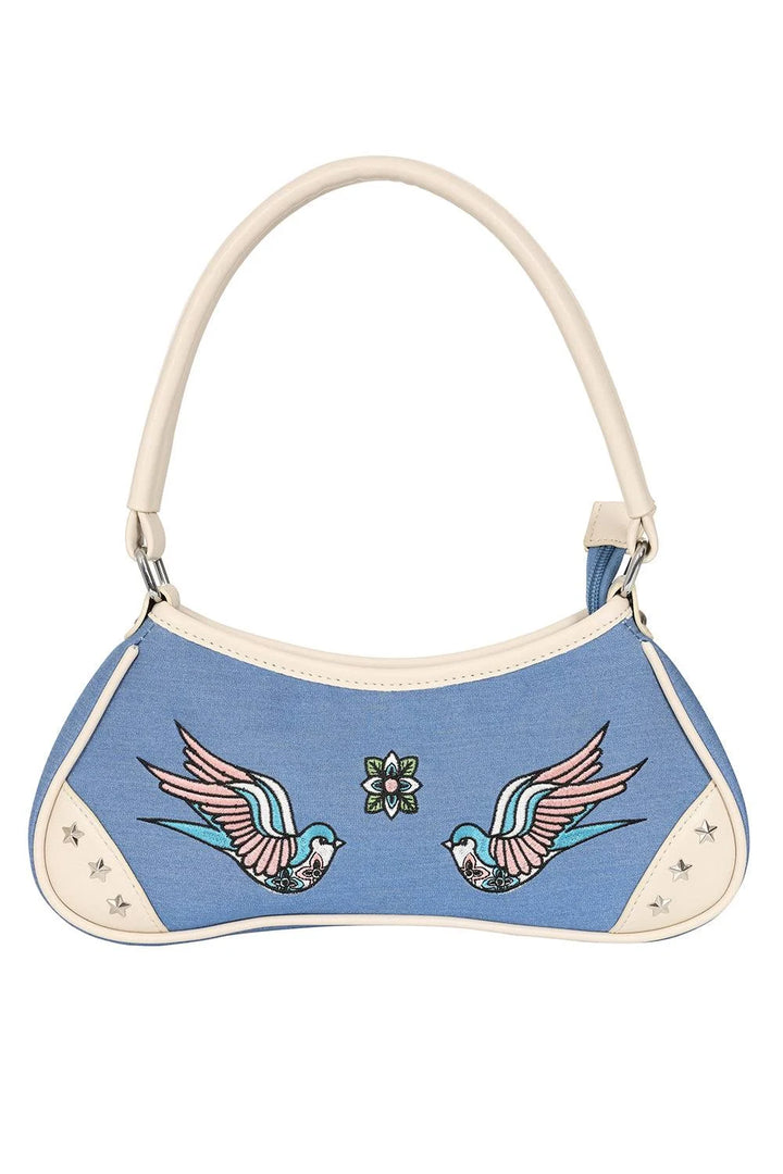 Blue handbag with bird designs on a white background
