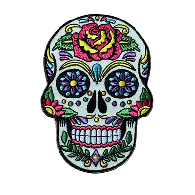 Colorful skull patch with floral designs on a wooden surface