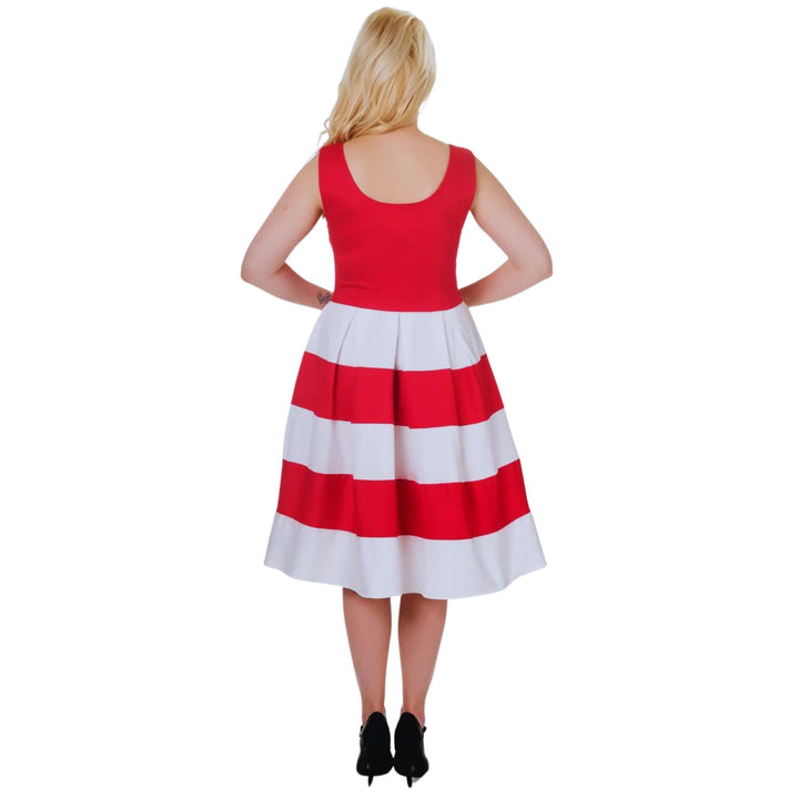 Back view of blonde lady wearing a red and white dress and heels