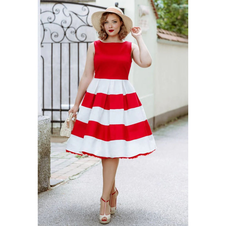 Tall lady wearing red and white dress with a sun hat, heel and holding a handbag