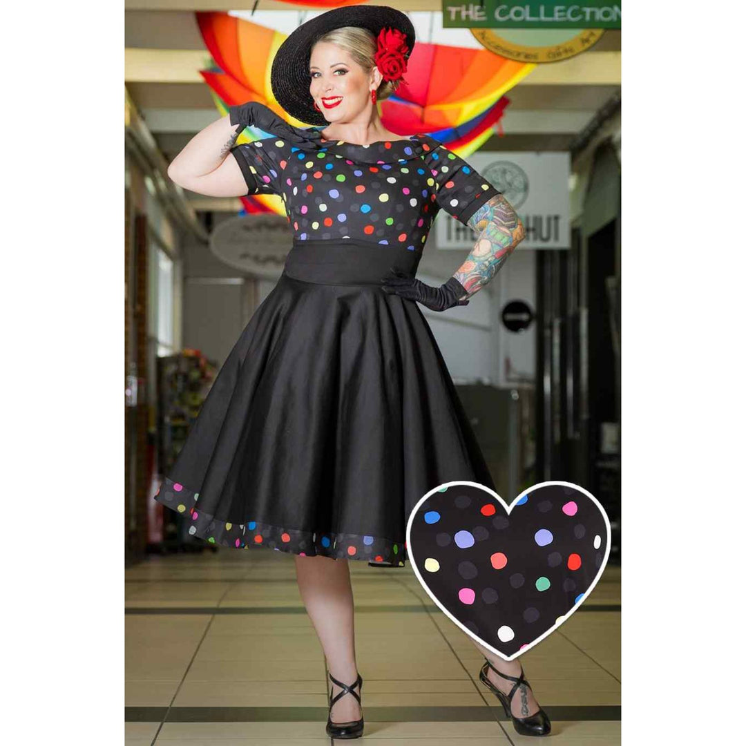 Image of lady wearing black dress with multicoloured polka dot dress posing for the camera
