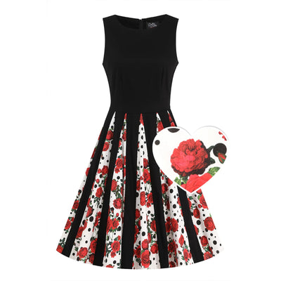 Front image of a black dress with white rose and polka dot pleats