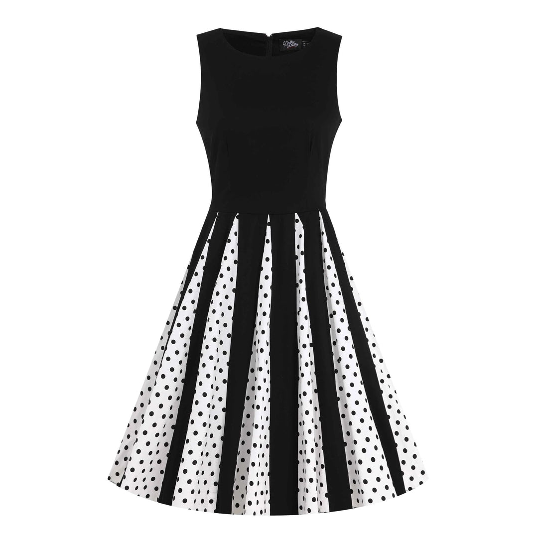 Front image of a black and white pleated dress with black polka dots from the waist down 