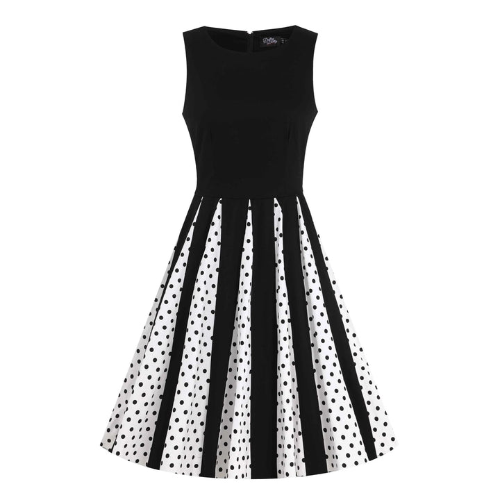 Front image of a black and white pleated dress with black polka dots from the waist down 