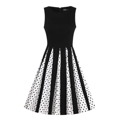 Front image of a black and white pleated dress with black polka dots from the waist down 