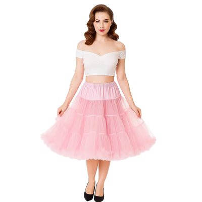 Woman wearing a white off-shoulder top and pink Petticoat skirt on a white background