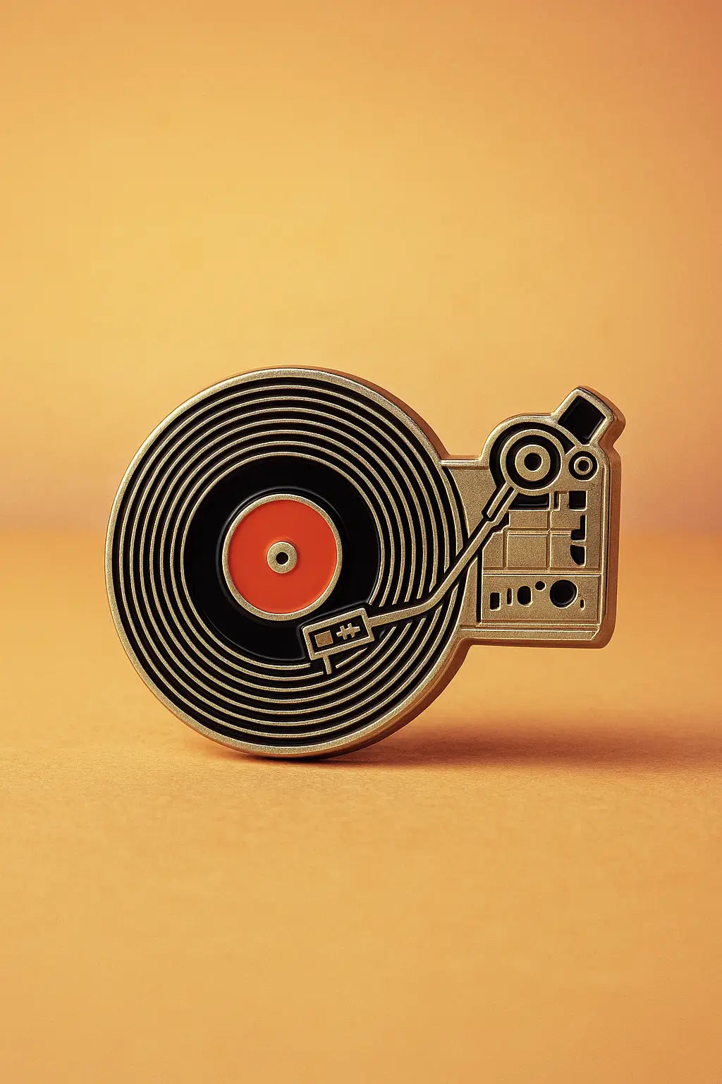 Decorative enamel pin shaped like a vintage record player with a black vinyl record on an orange background.