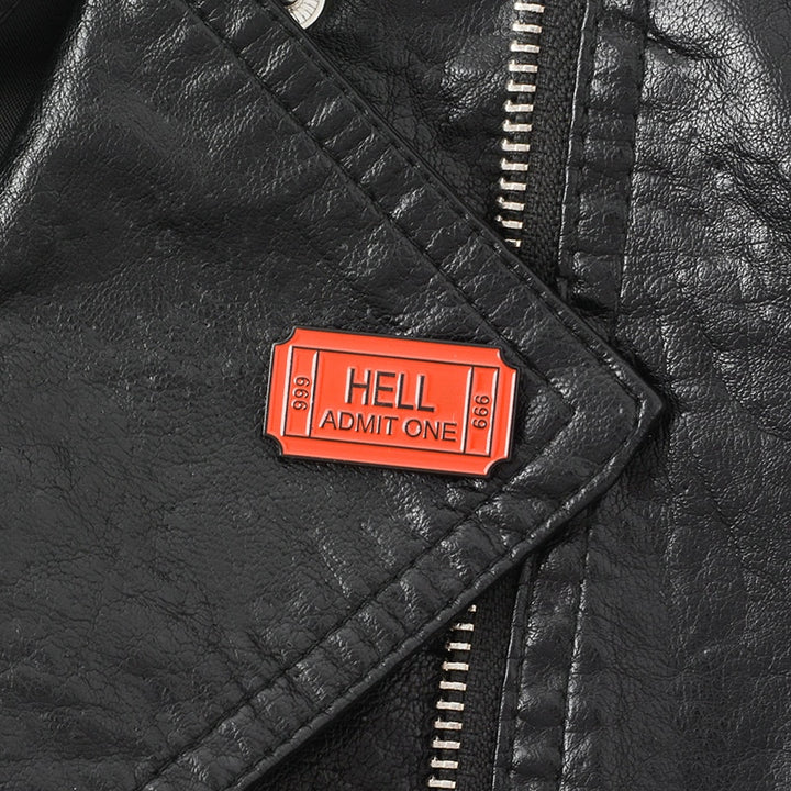 Black leather jacket lapel with a Red enamel pin saying "Hell Admit One 666"
