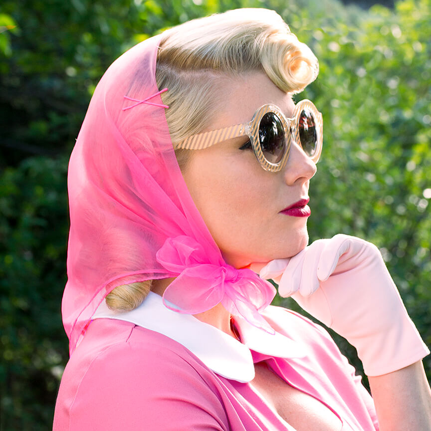 Image of model wearing Vintage Hairstyling Tidy Tresses Hair Scarf - Hot Pink - with gloves and sunnies