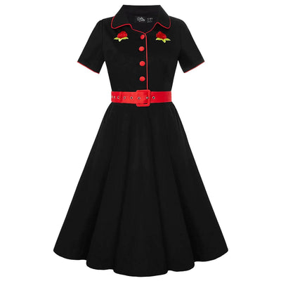 Front view of a black diner dress with a red belt  and red pipping details and embroidered roses  