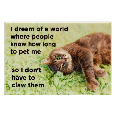 a cat laying on its side on a green shag rug and text " I dream of a world where people know how long to pet me so I don't have to claw them" fridge magnet