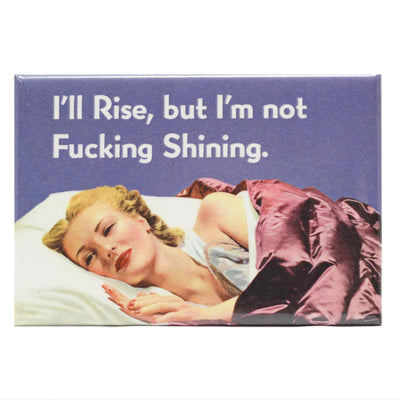 1950s looking girl in bed with the text "I'll Rise, but I'm not fucking shining" on a rectangle refrigerator magnet