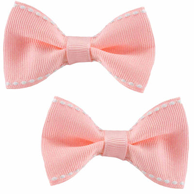 set of 2two retro hair bows in a light pink with white stiching detailing