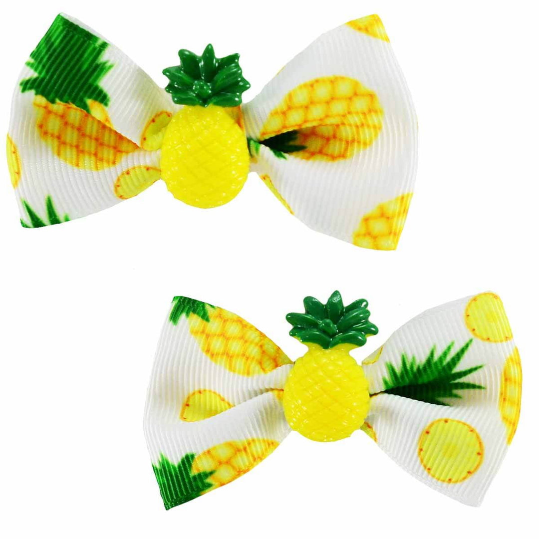 2 Pineapple motif hair bows with a resin pineapple in the middle of each bow