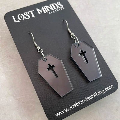 a pair of Charcoal hook earrings in the shape of a coffin with a cross