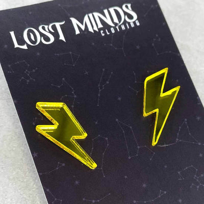 Alternative 80s retro stud earrings in the shape of lightning bolts in a yellow mirror acrylic