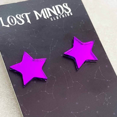 Gothic Alternative purple star shapped stud earrings on black cardboard packaging