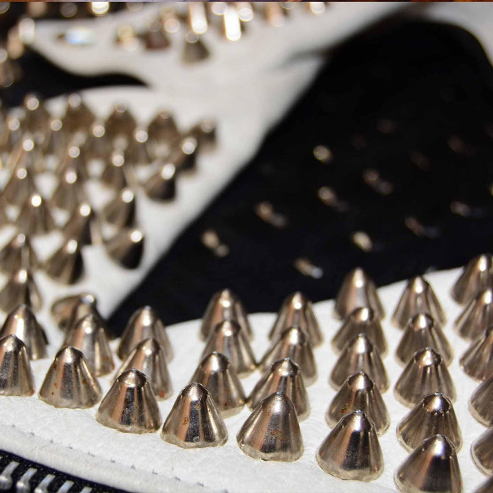 UK77 cone studed on the lapels of a black leather jacket